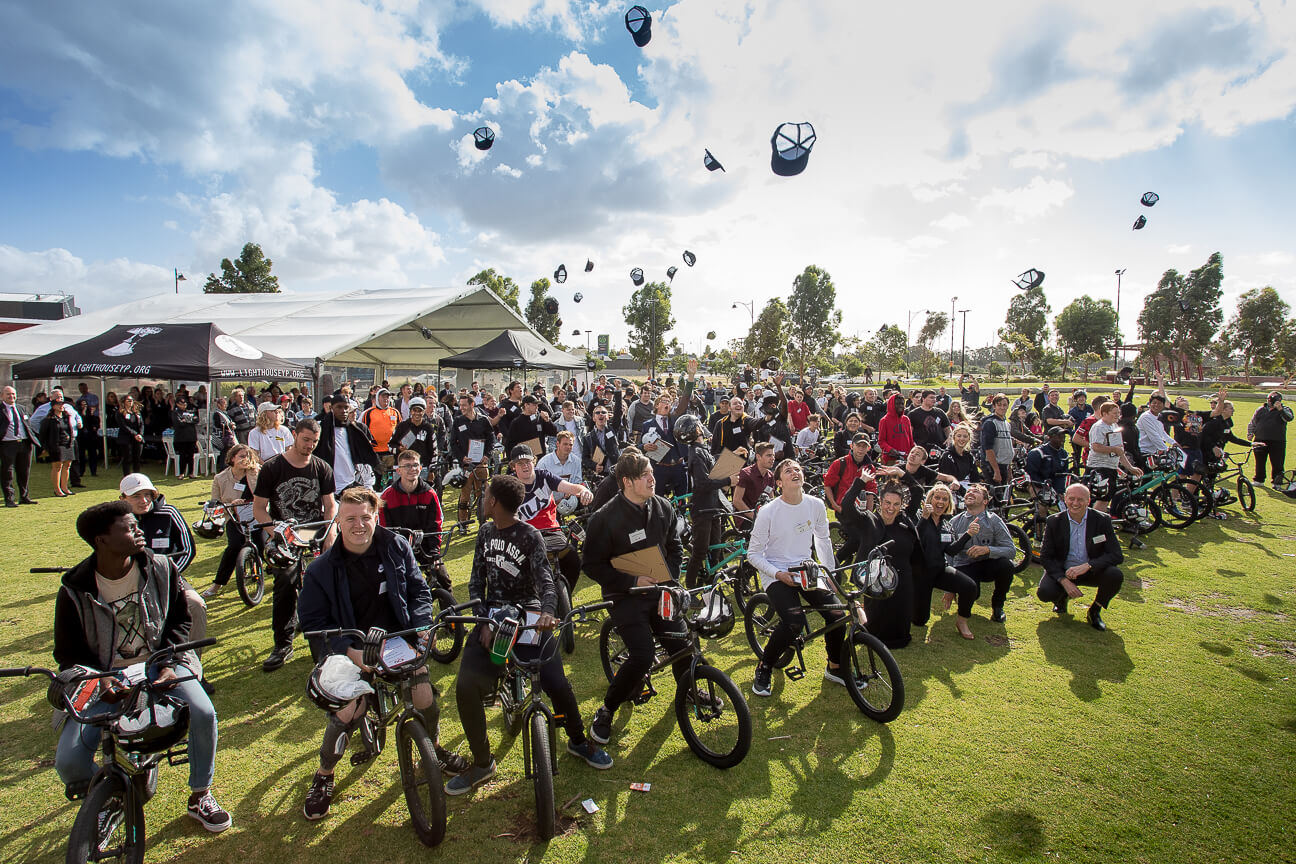 Panoramic image of large group of young people on BMX bikes